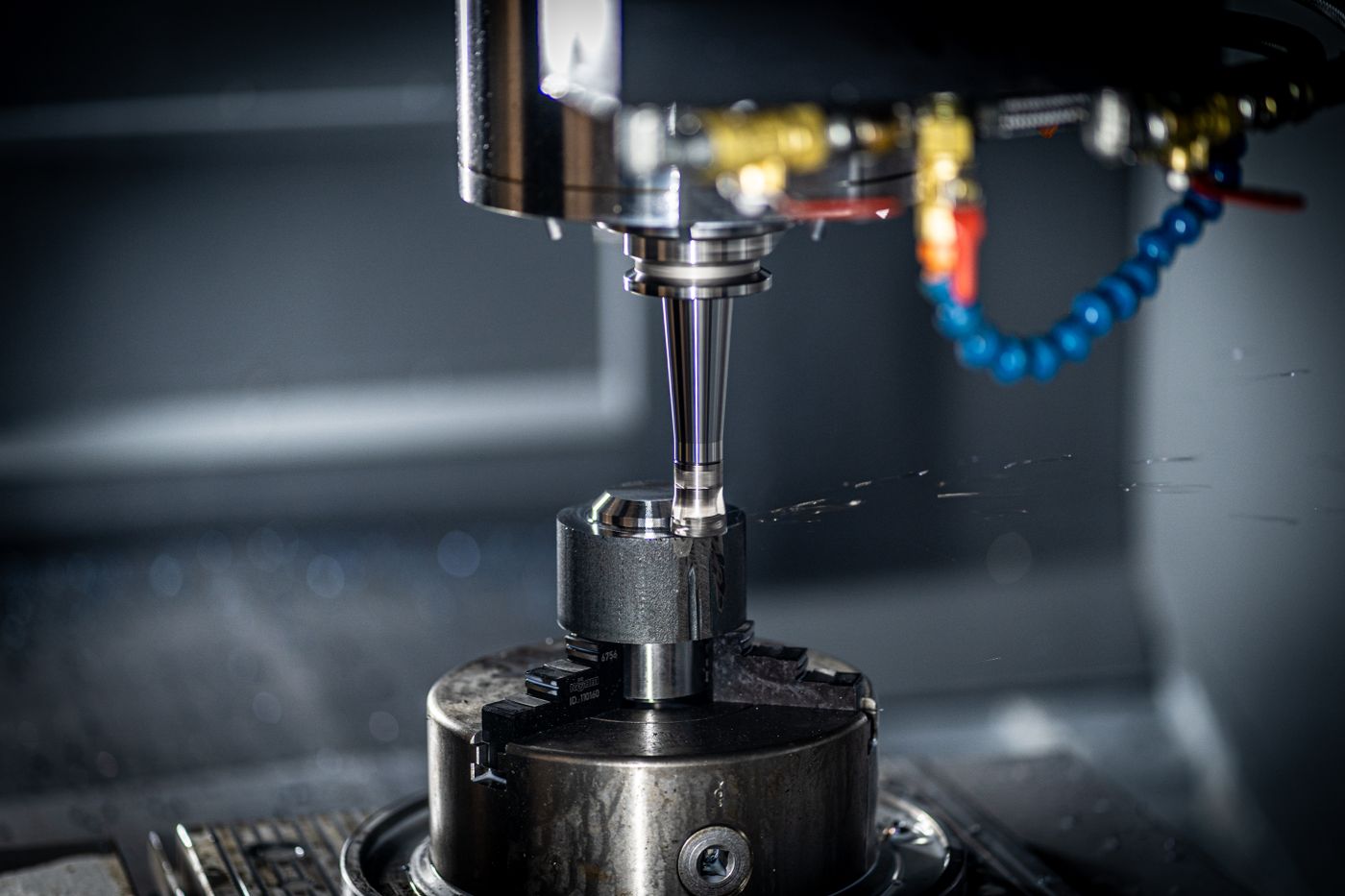 CNC machining center cutting metal with tooling in the spindle